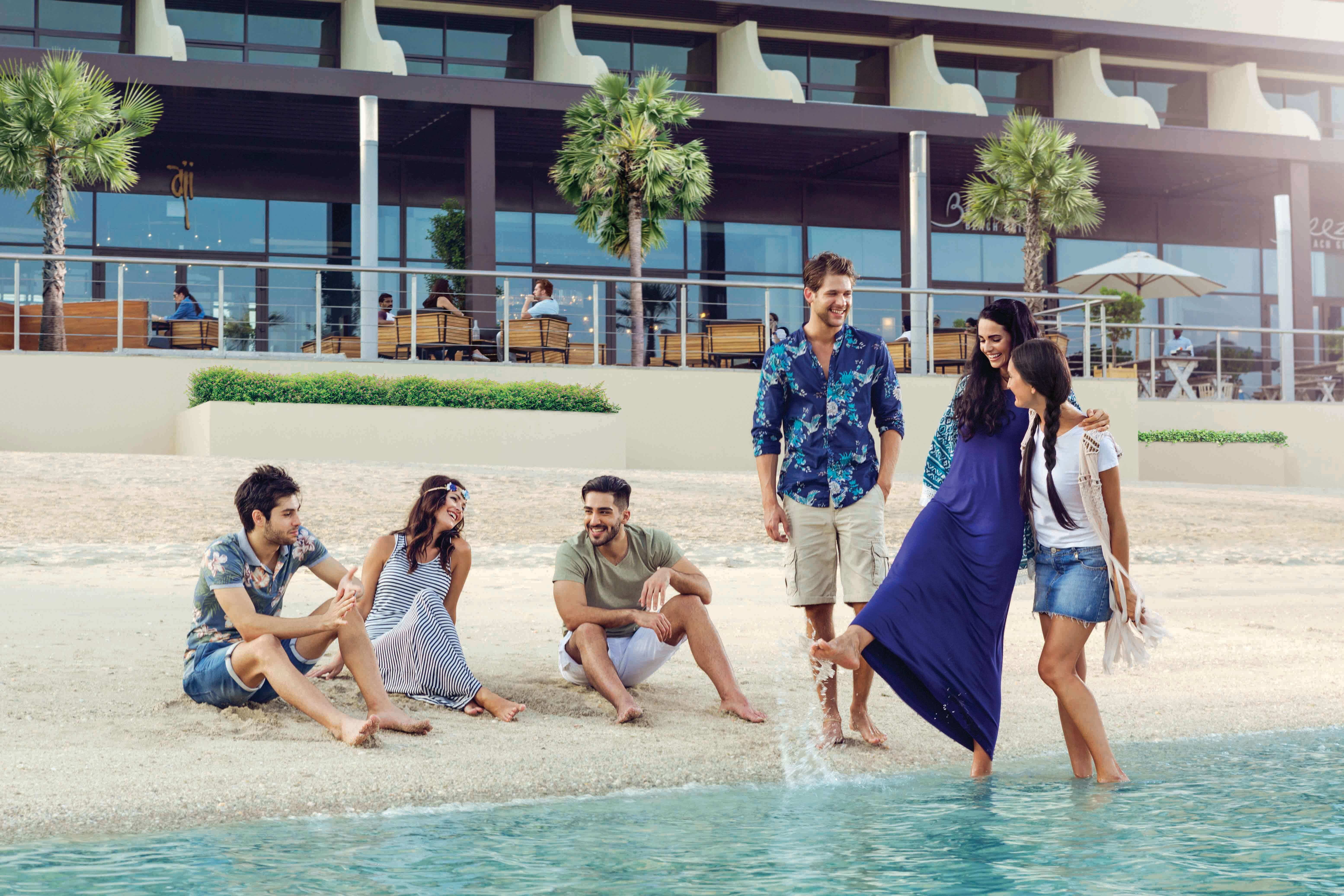 A family walking at The Pointe's beachside in Dubai